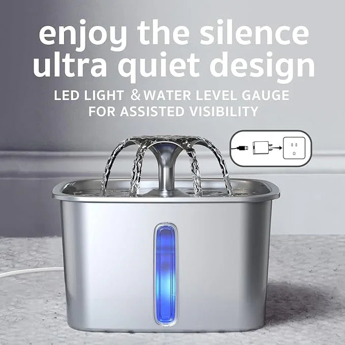 Stainless steel pet water fountain with LED light and water level gauge on gray floor.