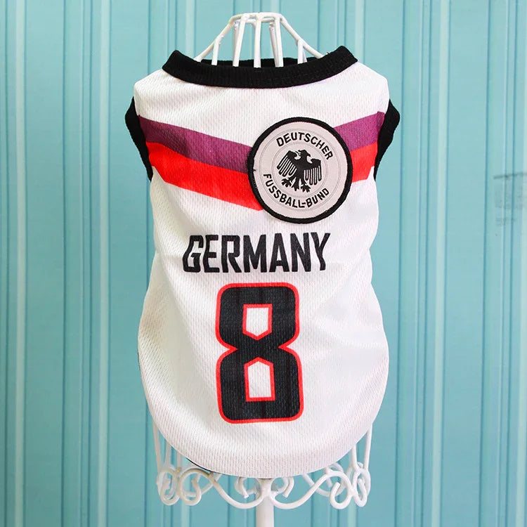 Germany soccer dog jersey with number 8 and German crest on a hanger, blue background